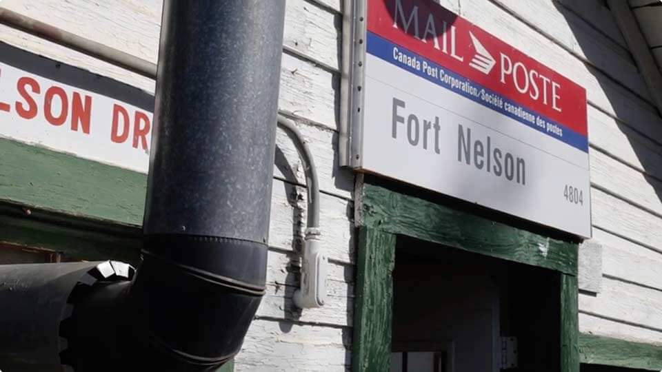 Fort Nelson sign on old building