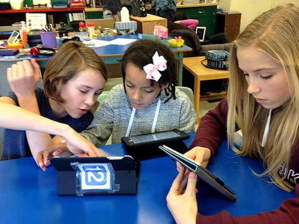 3 students with iPads