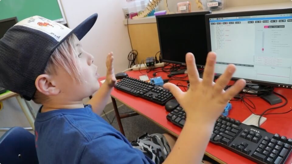 excited boy uses computer