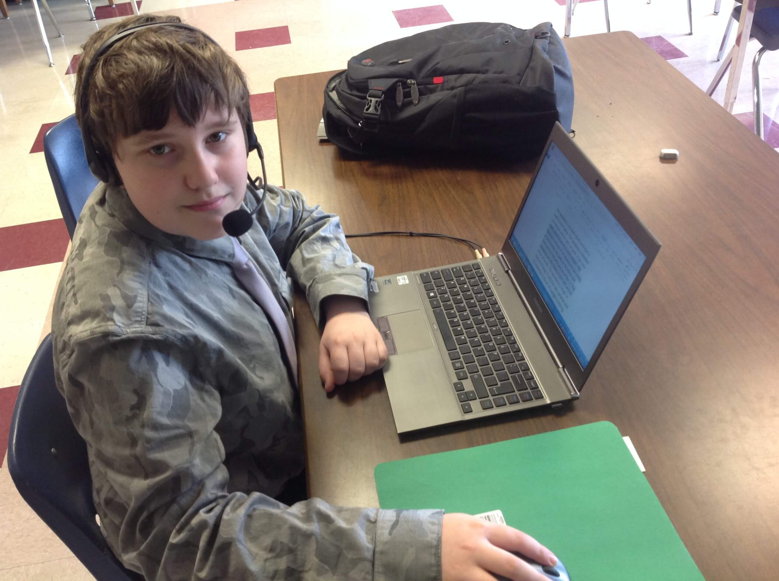 student using headset and laptop